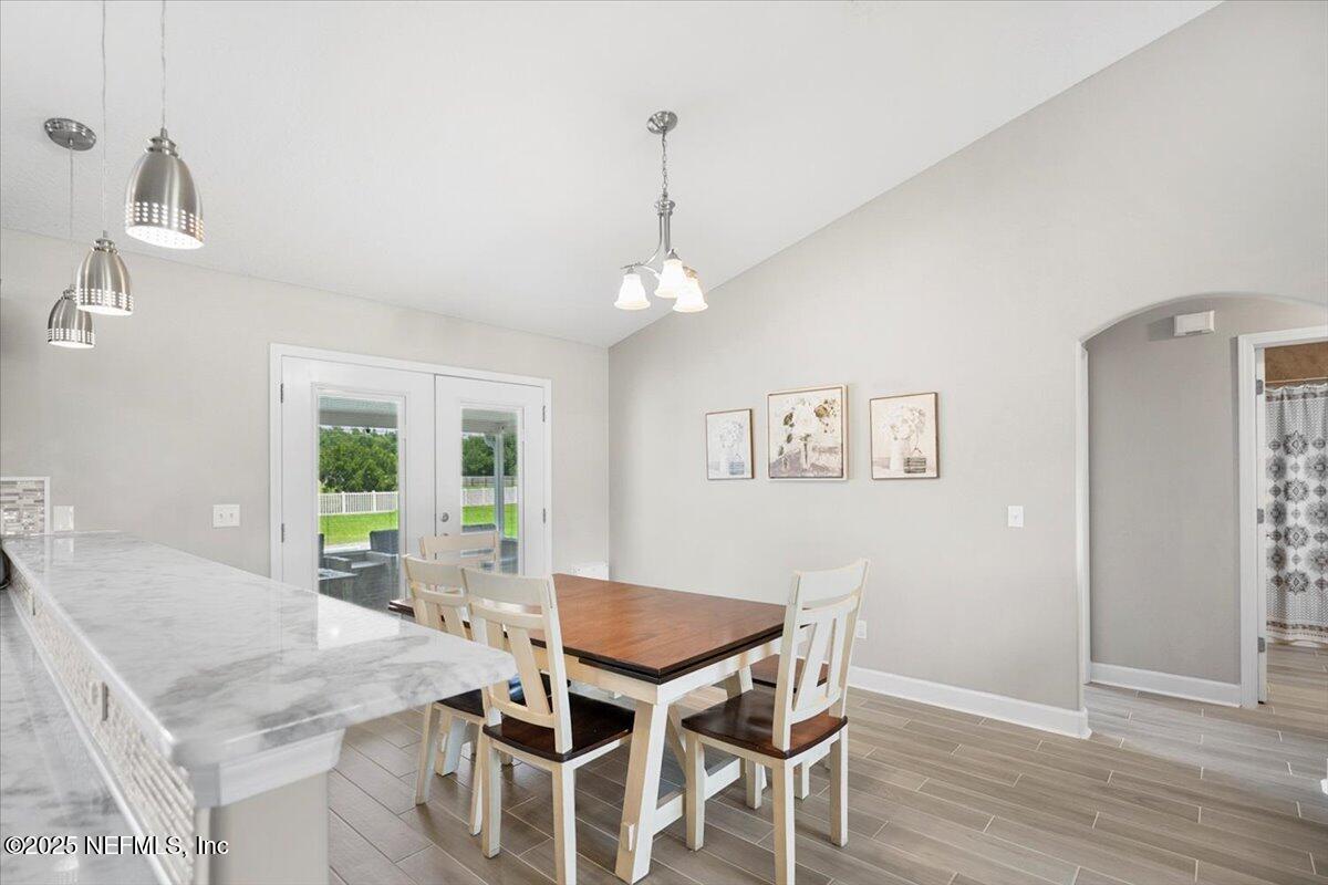 53347 Clear Lake Drive Callahan, FL 32011 - Photo 10 of 41 a dining room with furniture a chandelier and wooden floor