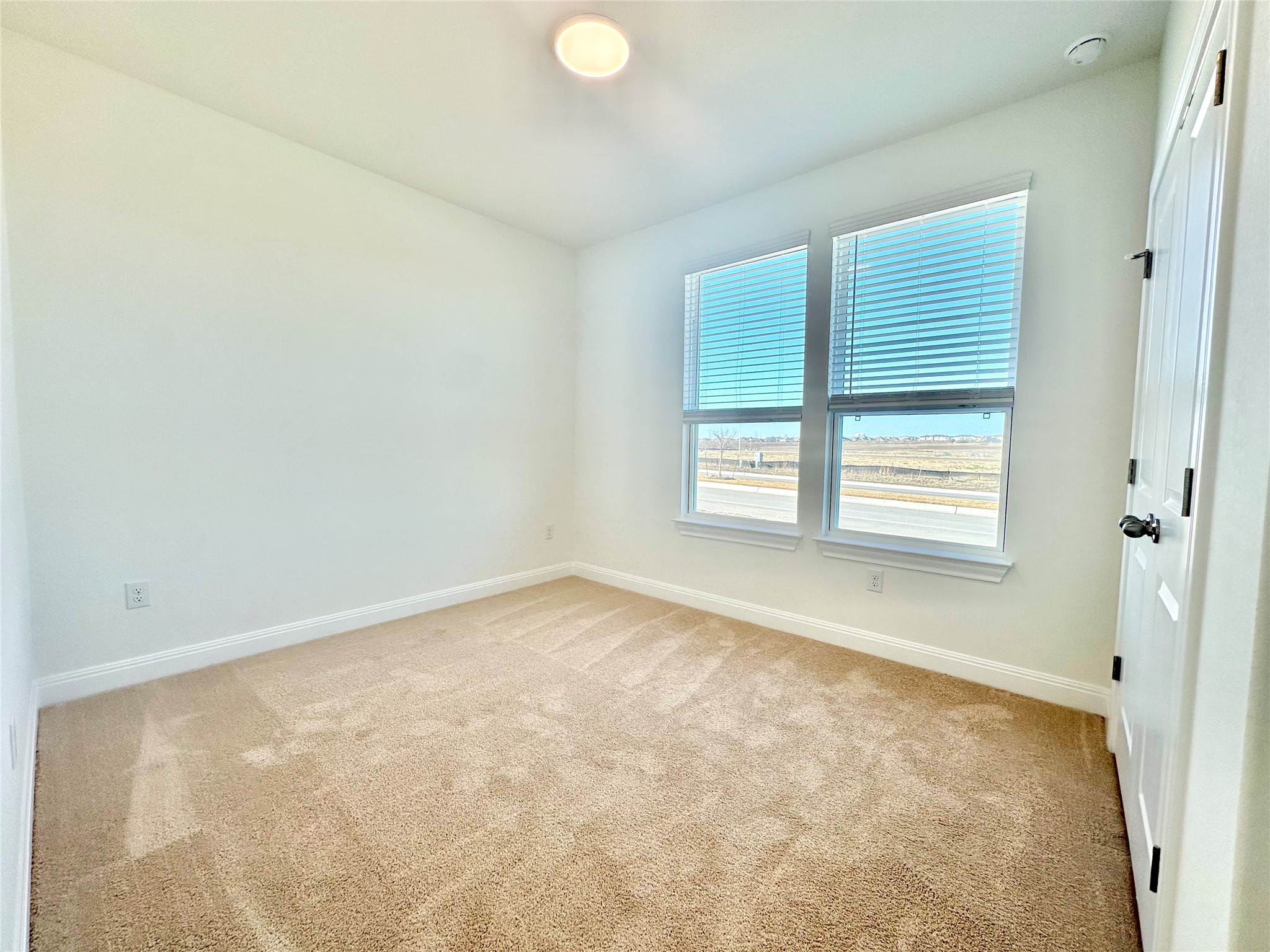 399 Porter Country Parkway Buda, TX 78610 - Photo 11 of 30 an empty room with windows