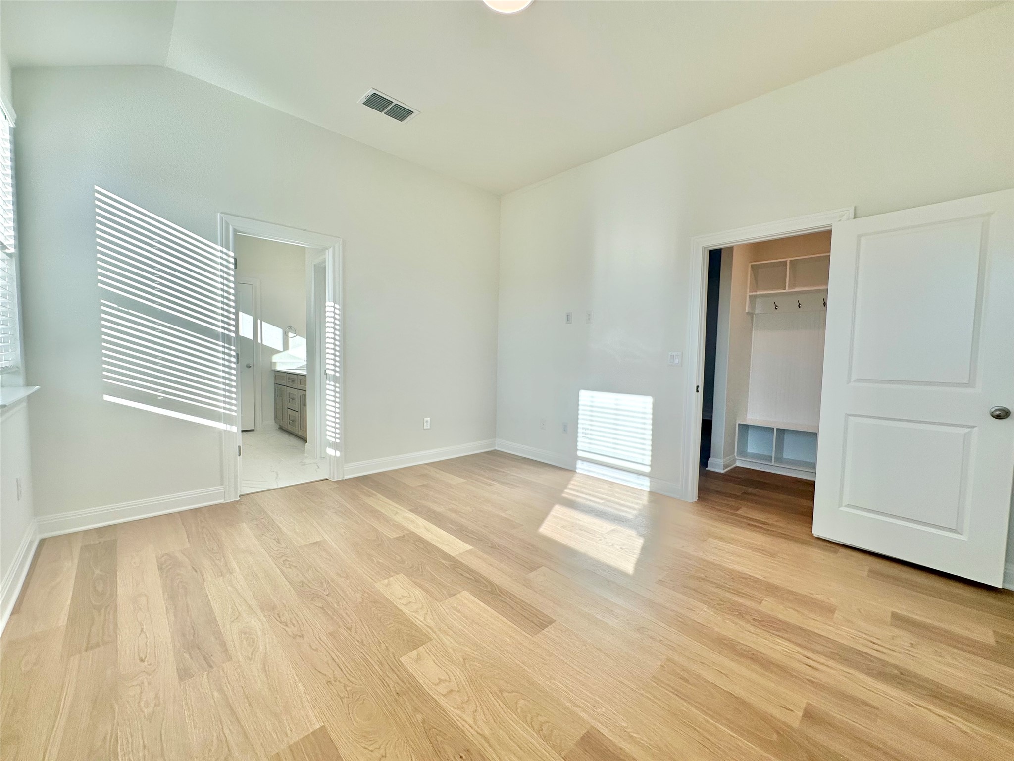 399 Porter Country Parkway Buda, TX 78610 - Photo 18 of 30 a view of an empty room with wooden floor and a window