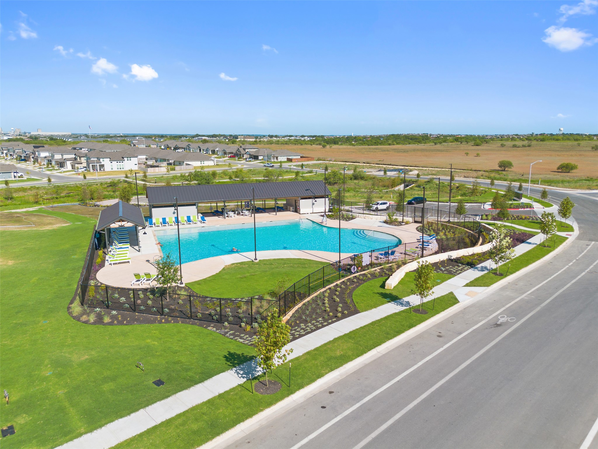 399 Porter Country Parkway Buda, TX 78610 - Photo 28 of 30 an aerial view of a swimming pool and lake view