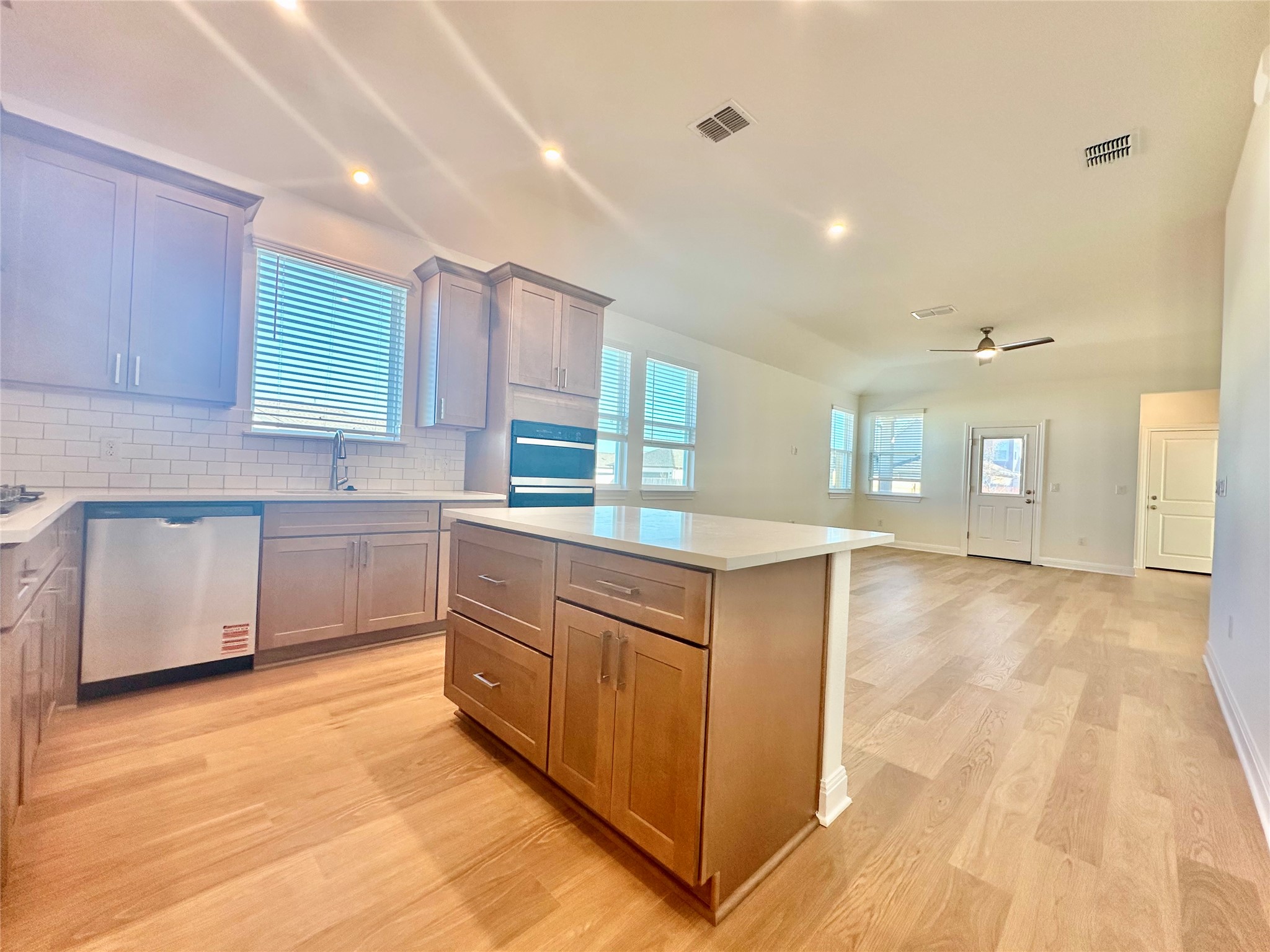 399 Porter Country Parkway Buda, TX 78610 - Photo 4 of 30 a kitchen with stainless steel appliances granite countertop a stove a sink and a refrigerator