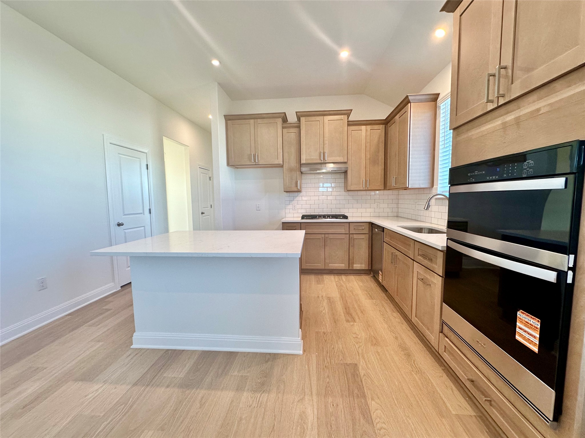399 Porter Country Parkway Buda, TX 78610 - Photo 7 of 30 a large kitchen with stainless steel appliances granite countertop a stove a sink and a microwave