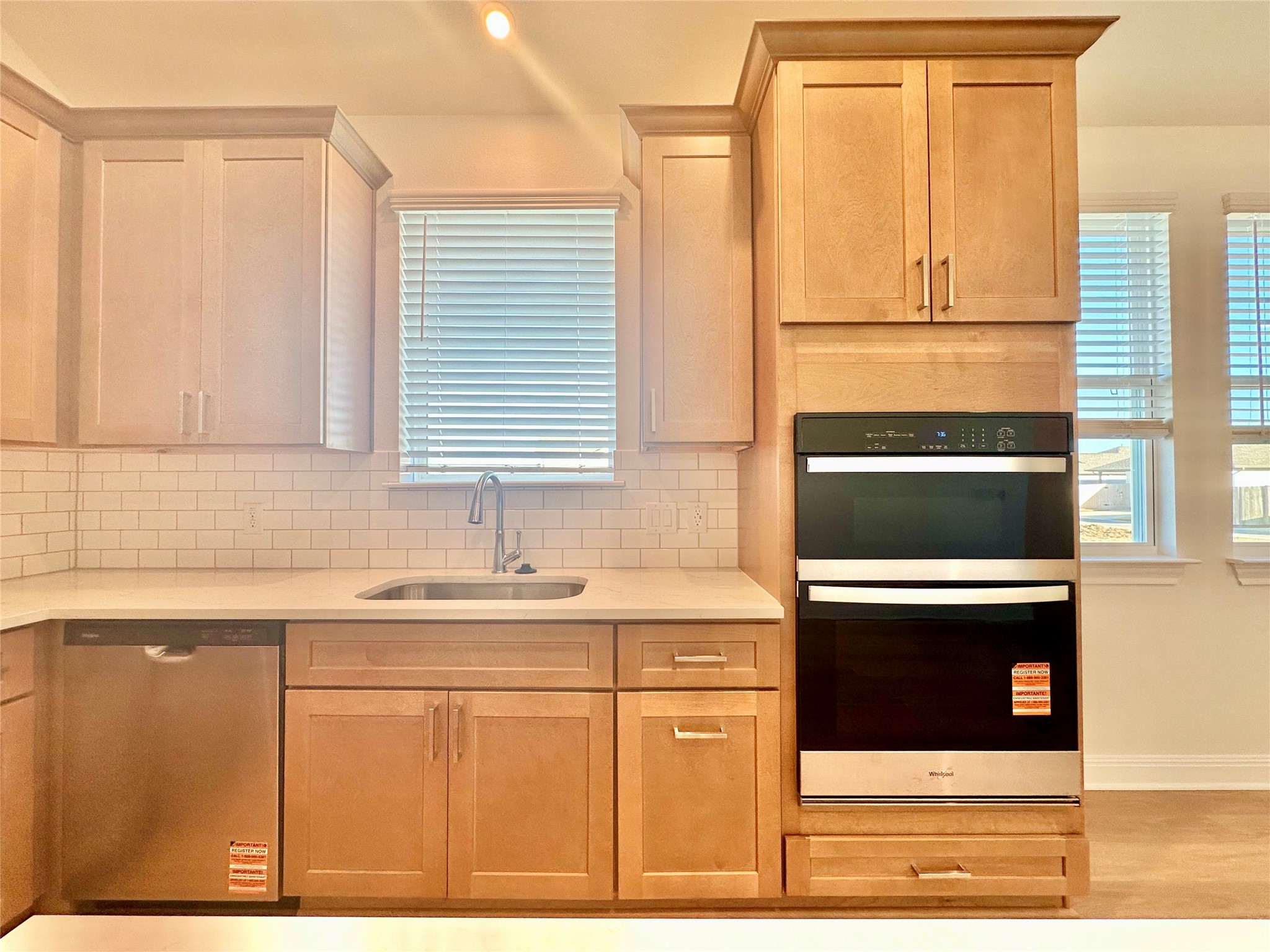 399 Porter Country Parkway Buda, TX 78610 - Photo 9 of 30 a kitchen with stainless steel appliances granite countertop a sink and a microwave