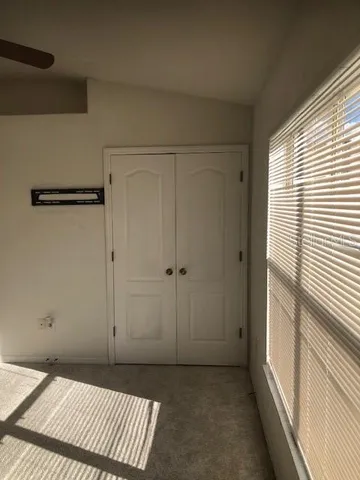 a view of an empty room and a window