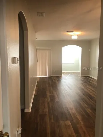 a view of hallway with wooden floor