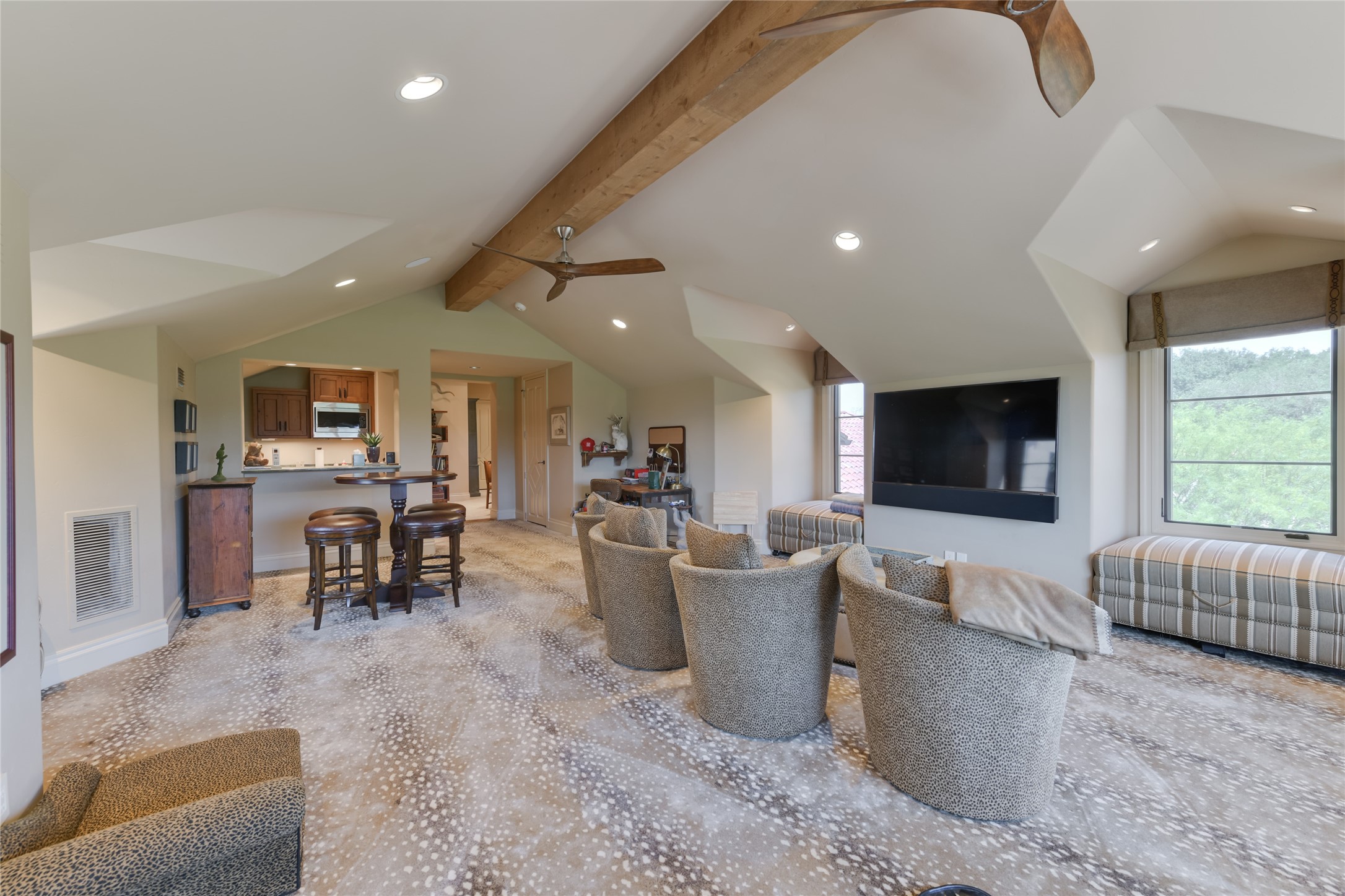 21729 Farm To Market 1887 Hempstead, TX 77445 - Photo 18 of 49 A conveniently located 2nd floor GAME ROOM (27 X 24) with its carpeted flooring, pitched ceiling with exposed wood beam/ceiling fans/recessed lighting/built-in speakers, dormer windows with built-in window benches (storage underneath), windows with Roman shades, two notable "big horn" light sconces, electronics closet and fully equipped WET BAR (marble counter/backsplash, bar seating, sink, wood floating shelves, cabinet front Scotsman ice maker, GE cabinet front mini refrigerator, stainless GE microwave).