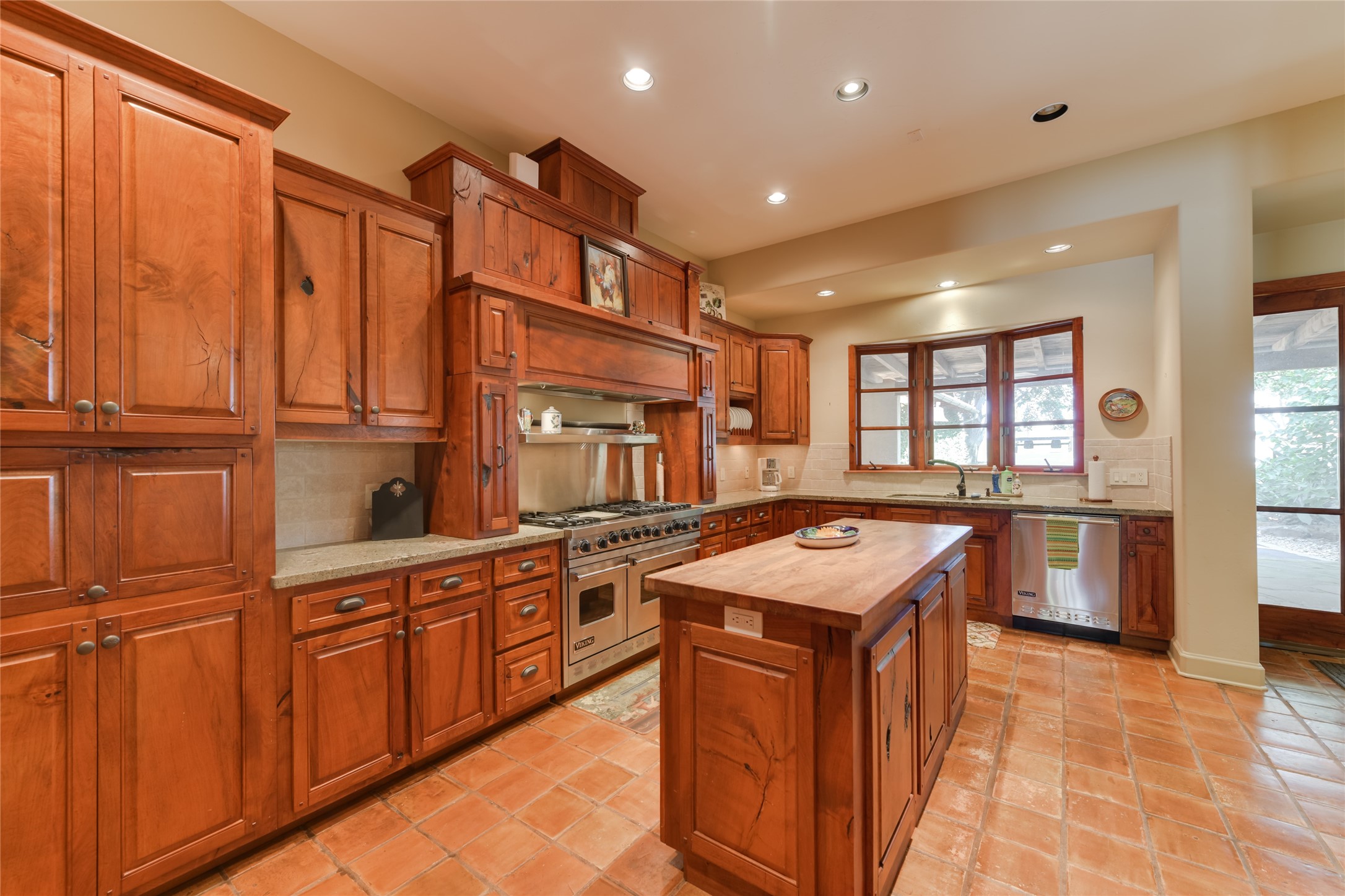 21729 Farm To Market 1887 Hempstead, TX 77445 - Photo 27 of 49 The KITCHEN (17 X 11) provides ample storage space with its stained wood cabinets/drawers with granite counters/stone backsplash. The center island features a butcher block counter. A wood framed bay window adds a charming coziness to the space while the stainless Viking appliances provide state of the art appliances for use by the cook!
