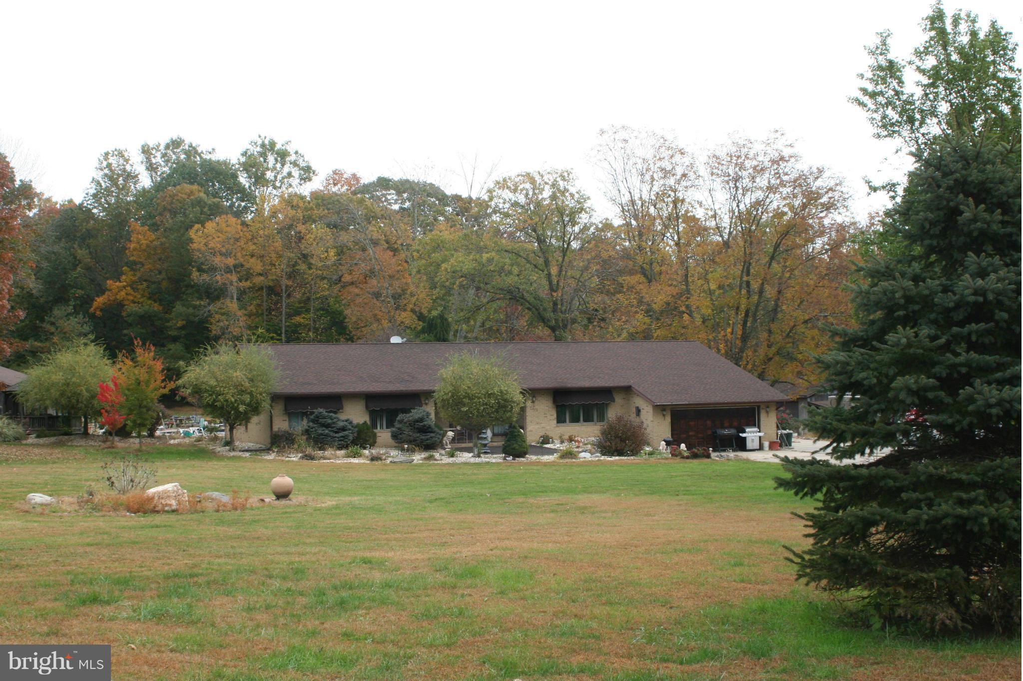 2812 Reckord Road Fallston, MD 21047 - Photo 1 of 4 a front view of a house with garden and trees