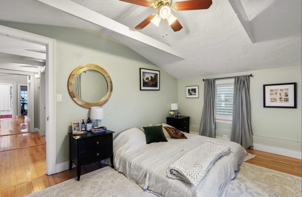 159 N Street Boston, MA 02127 - Photo 10 of 13 a bedroom with a bed and a chandelier