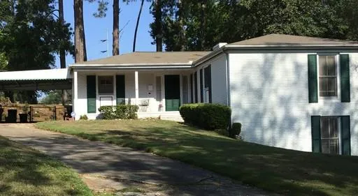 a view of a house with backyard and porch