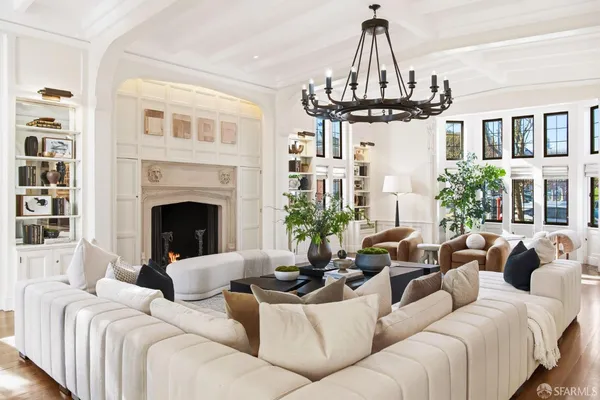 a kitchen with stainless steel appliances granite countertop a table chairs and a chandelier