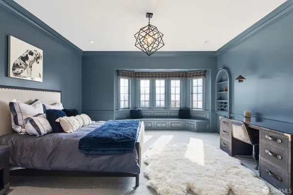 a spacious bedroom with a bed and a cabinets