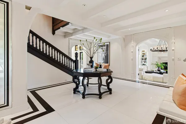 a living room with furniture chandelier and a fireplace