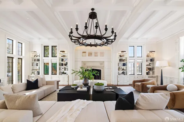 a living room with furniture potted plant and a chandelier