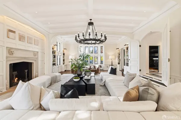 a living room with furniture fireplace and window