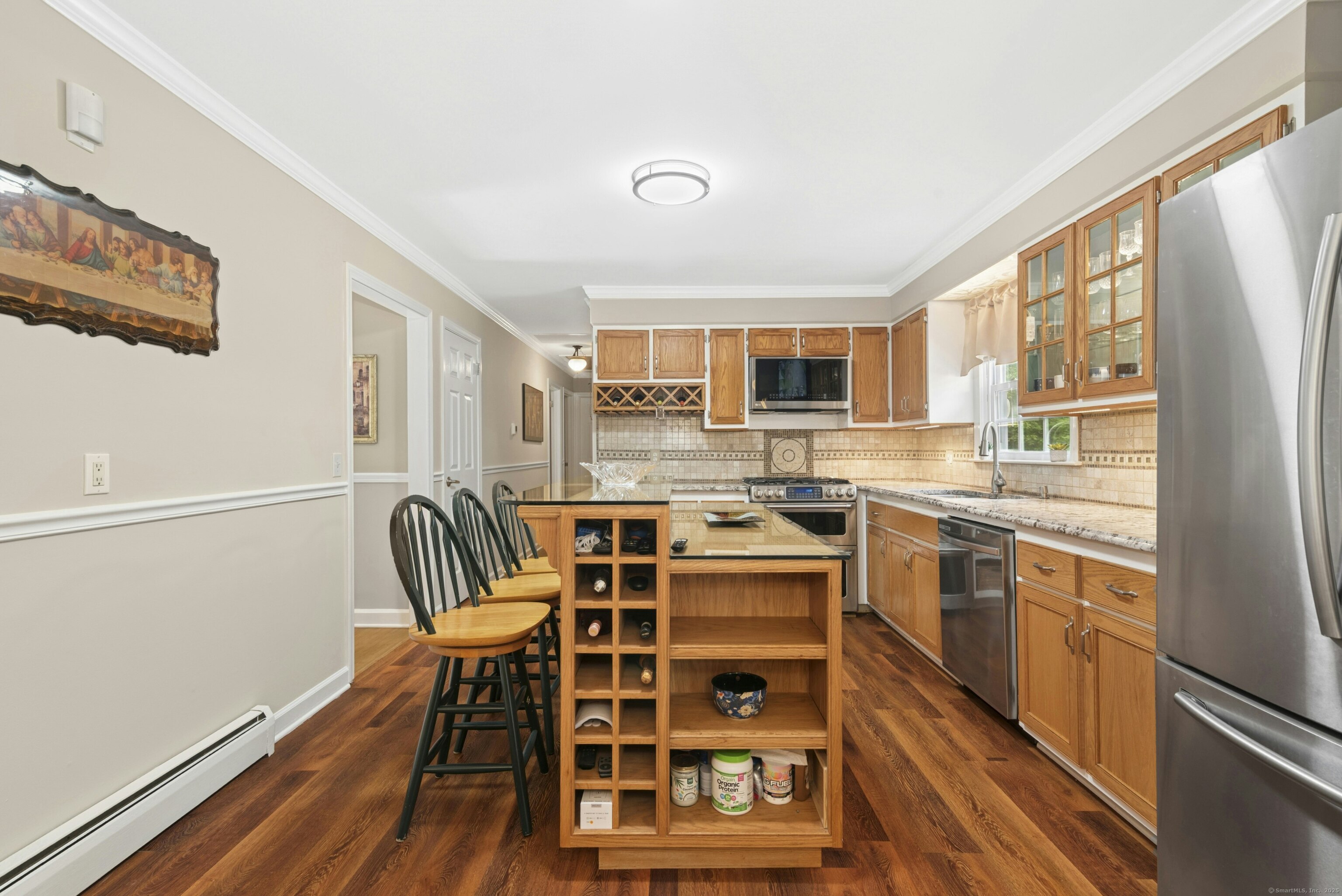 40 Winthrop Place Monroe, CT 06468 - Photo 15 of 38 a kitchen with stainless steel appliances a stove a sink dishwasher a refrigerator with a dining table and chairs