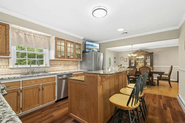 a kitchen with stainless steel appliances granite countertop a sink stove and cabinets