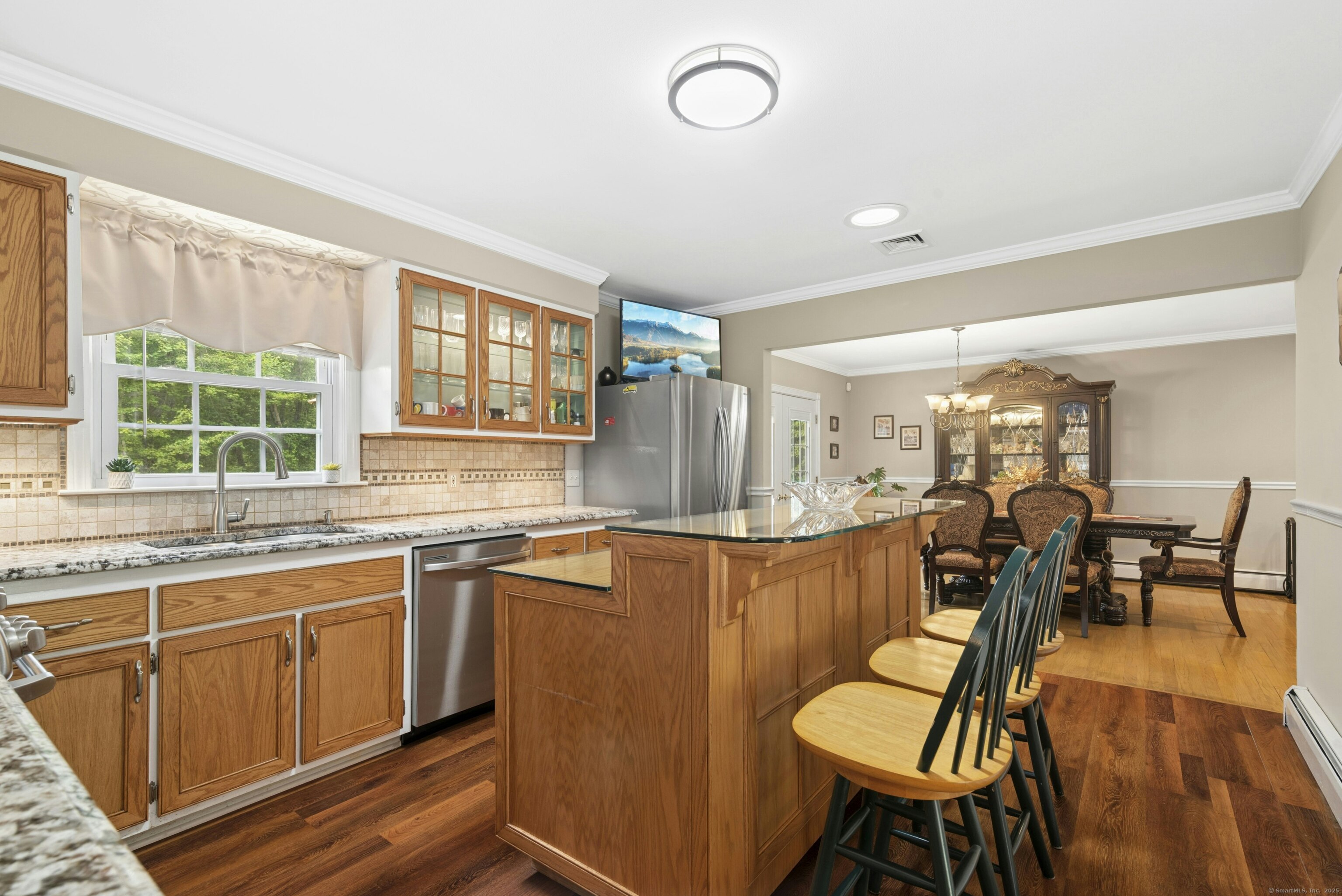 40 Winthrop Place Monroe, CT 06468 - Photo 16 of 38 a kitchen with stainless steel appliances granite countertop a stove a sink a dining table and chairs