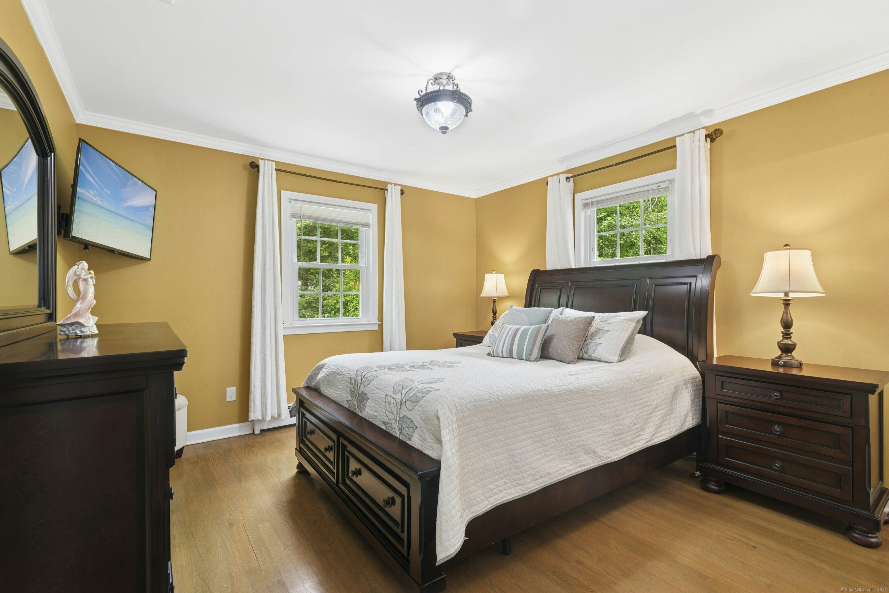 40 Winthrop Place Monroe, CT 06468 - Photo 18 of 38 a bedroom with a bed and a lamp on dresser next to a window