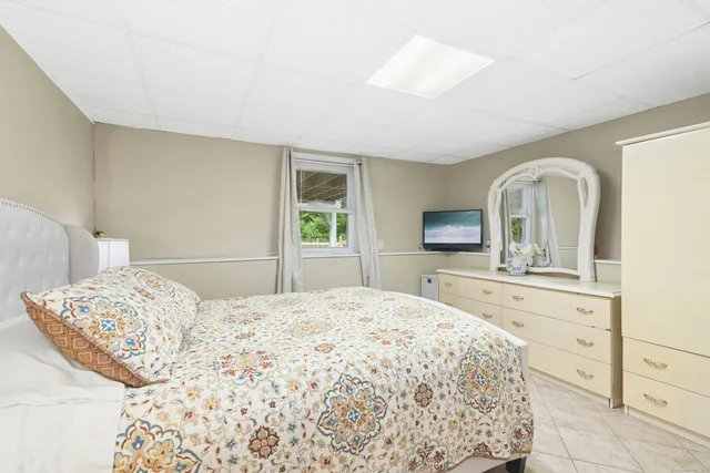 a bathroom with a toilet a sink a shower and mirror