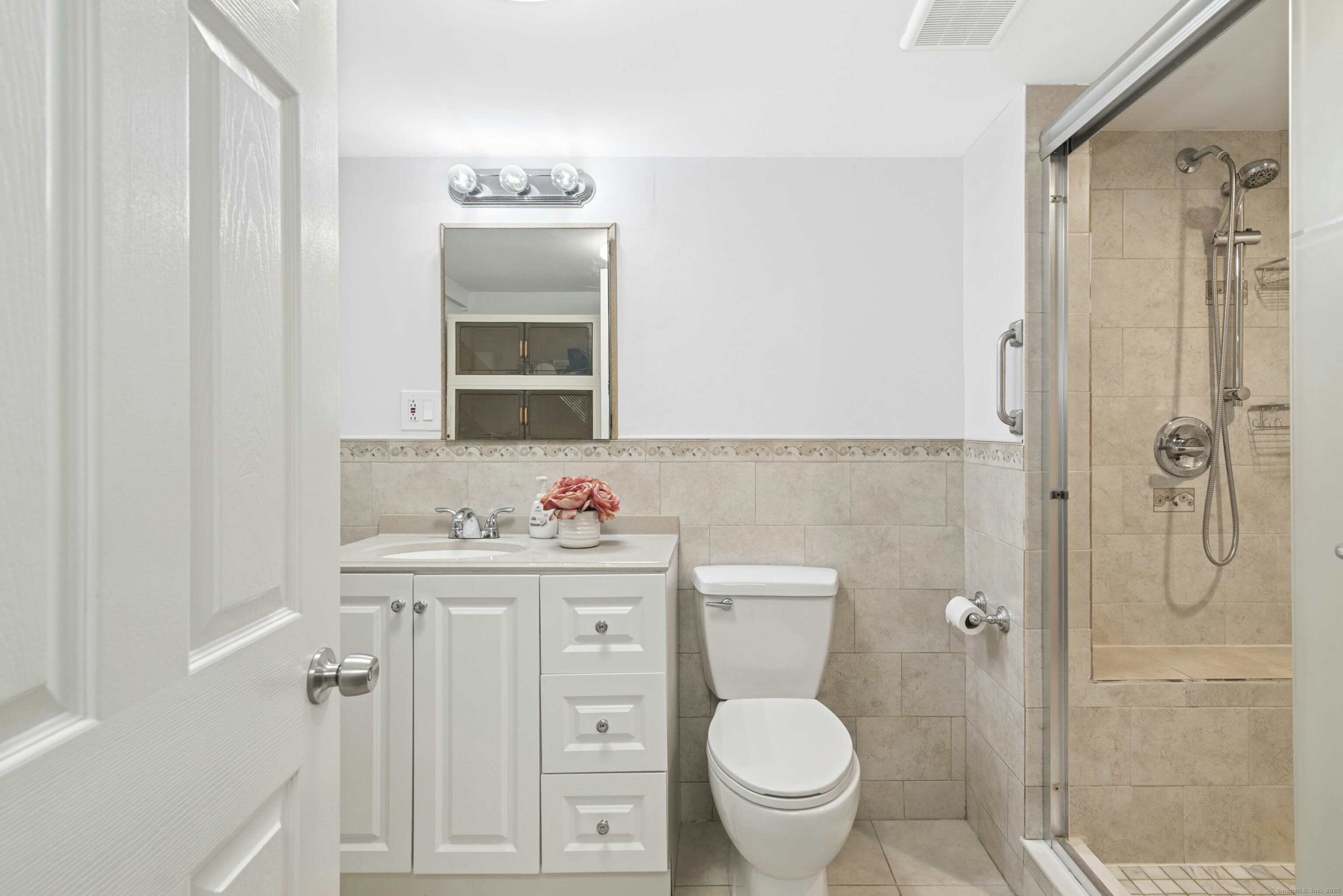 40 Winthrop Place Monroe, CT 06468 - Photo 27 of 38 a bathroom with a toilet a sink a shower and mirror