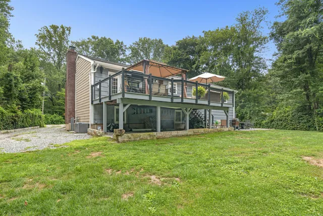 a view of a green yard with wooden fence