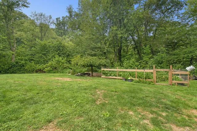 a front view of house with yard and trees