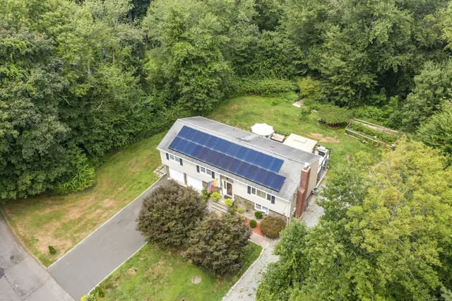 an aerial view of a house with a yard