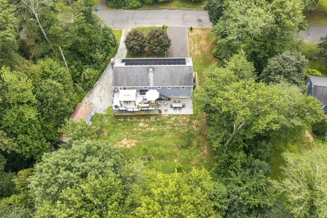 an aerial view of a house with a yard