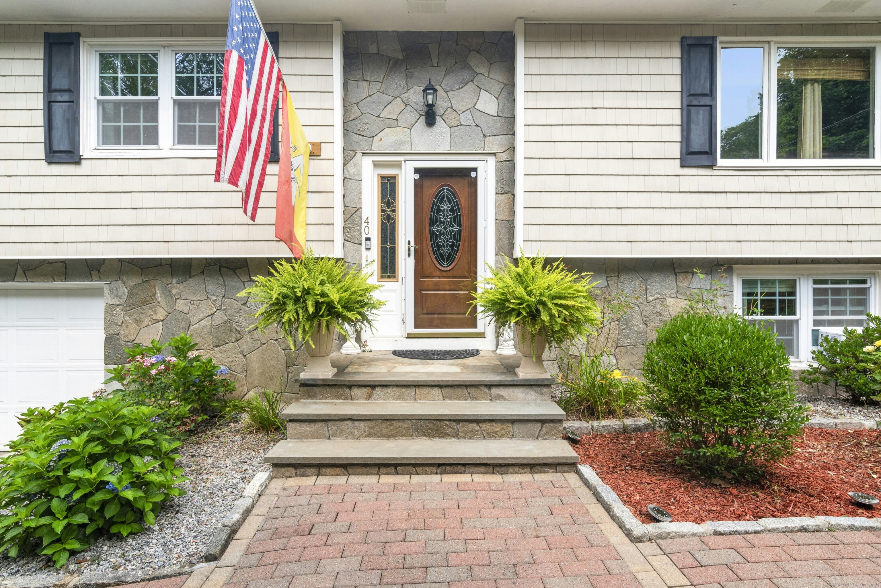 40 Winthrop Place Monroe, CT 06468 - Photo 7 of 38 a view of a house with potted plants and a large window