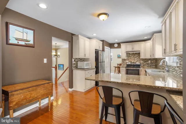 a kitchen with granite countertop wooden cabinets and stainless steel appliances