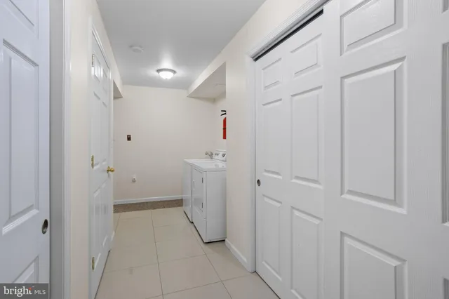 a living room with furniture a flat screen tv and a window