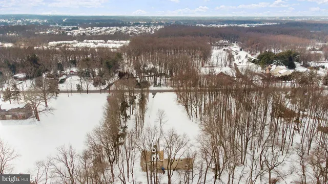 a bed with a white comforter and pillows