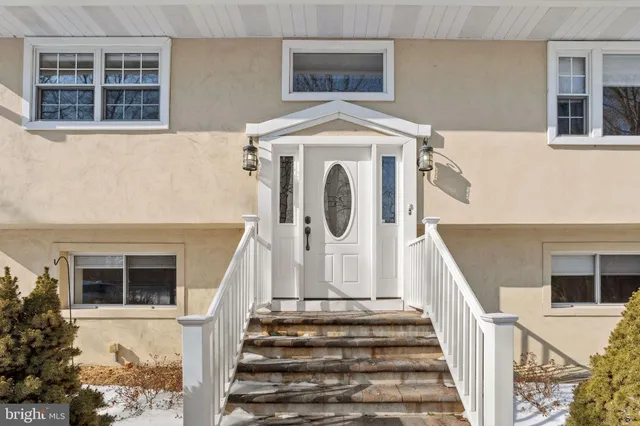 a view of entryway with wooden floor and a front door