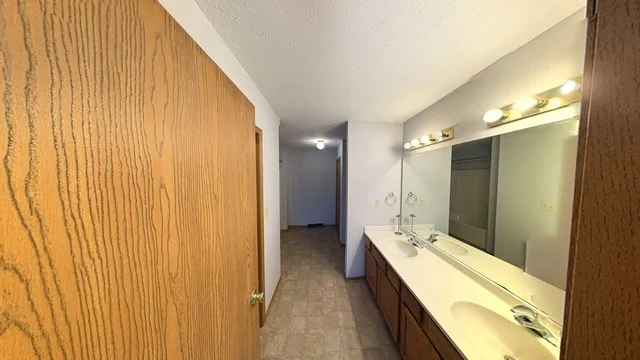 a bathroom with a double vanity sink and mirror