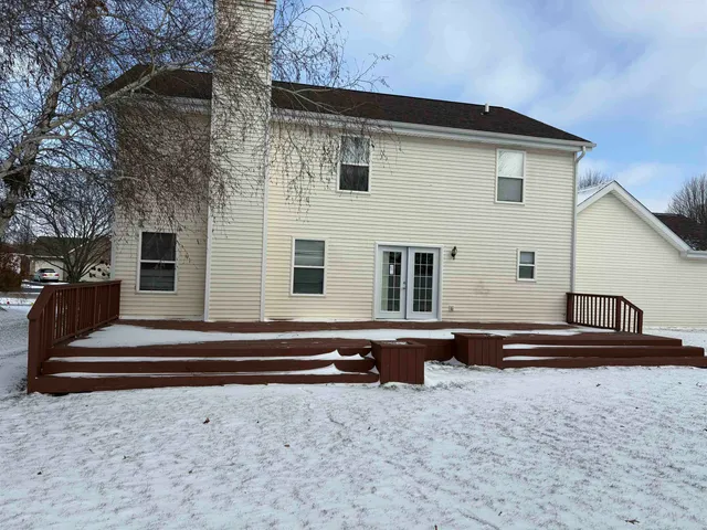 a view of a house with a wooden fence
