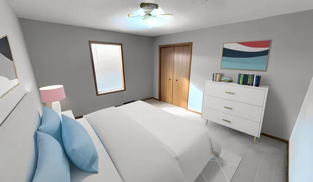 a bedroom with a large bed and a flat tv screen on a dresser