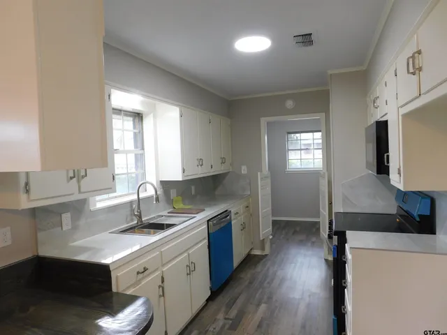 a kitchen with a sink stove and refrigerator