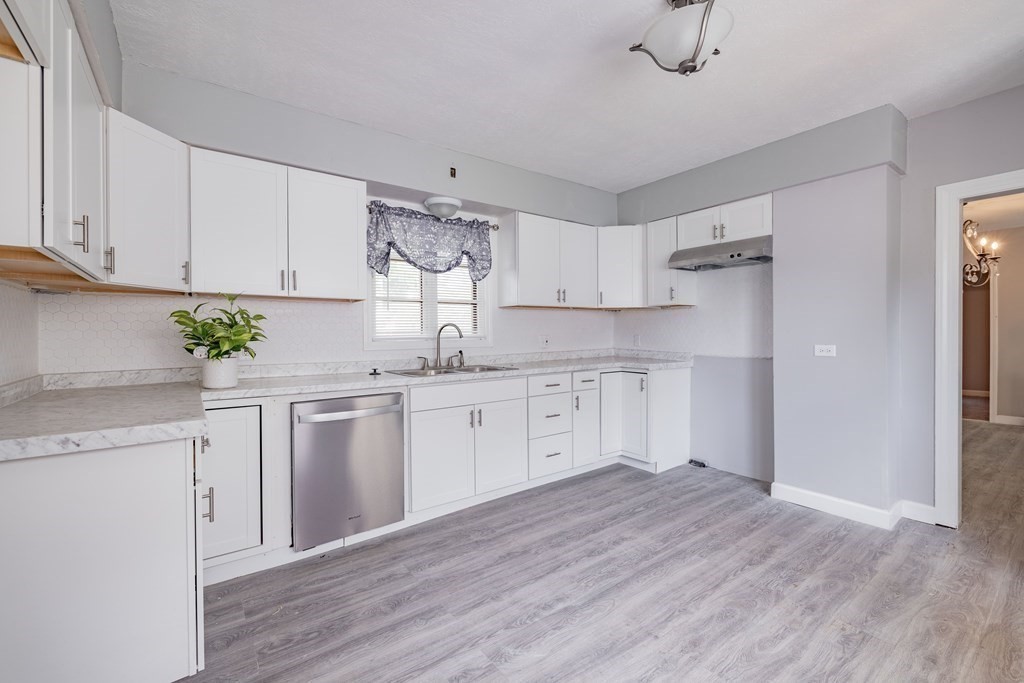 17 Spring Street Ware, MA 01082 - Photo 2 of 28 a kitchen with granite countertop white cabinets and white appliances