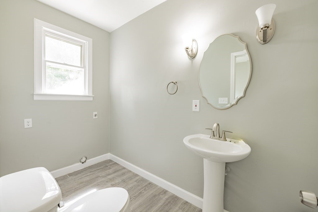 17 Spring Street Ware, MA 01082 - Photo 21 of 28 a bathroom with a toilet sink and mirror