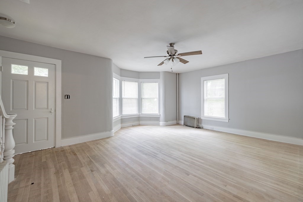 17 Spring Street Ware, MA 01082 - Photo 22 of 28 a view of an empty room with a window and wooden floor