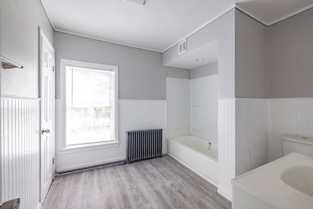 17 Spring Street Ware, MA 01082 - Photo 26 of 28 a bathroom with a bathtub and a window