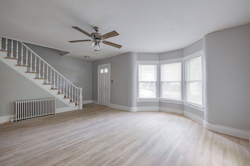17 Spring Street Ware, MA 01082 - Photo 3 of 28 a view of an empty room with wooden floor and a window
