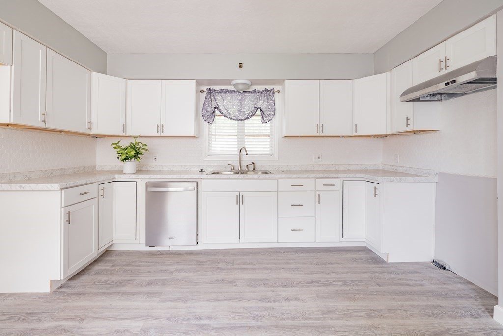17 Spring Street Ware, MA 01082 - Photo 9 of 28 a kitchen with white cabinets and white appliances