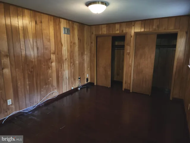a view of an empty room with wooden walls