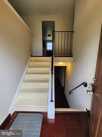 a view of entryway and hall with wooden floor