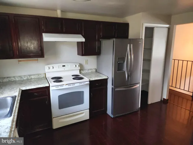 a kitchen with a stove refrigerator and a microwave