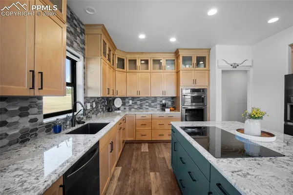 a kitchen with a sink stove top oven and refrigerator