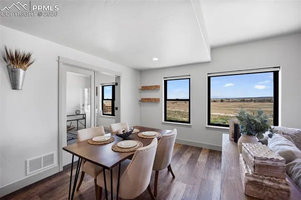 a view of a dining room with furniture window and wooden floor