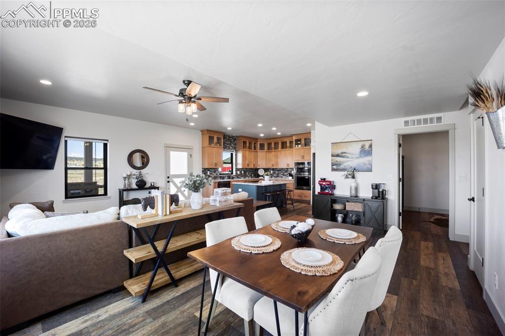 16535 Sweet Road Peyton, CO 80831 - Photo 15 of 45 a view of a dining room with furniture and wooden floor